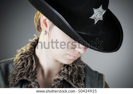 Stylish tinted portrait of a woman in a hat tips