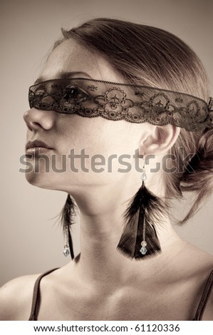 Beautiful woman with eyes covered with black band.