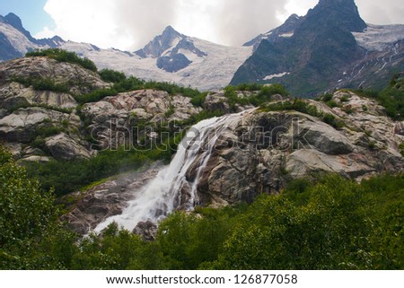 Waterfall flowing from Alibeksky glacier, Western Caucasus, Russia
