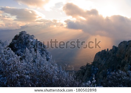 The rays of the setting sun illuminate the rock Demerdzhi. Crimea