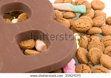 A chocolate letter with Sinterklaas candy isolated on white background