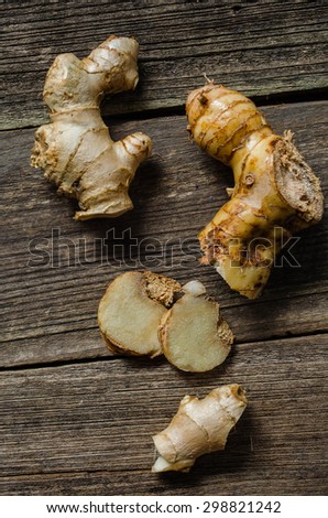 Ginger root sliced on wooden background