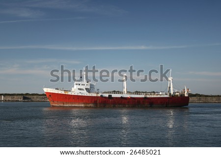 Large red ship leaving the harbor
