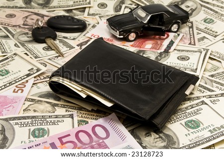 Car key, keychain,  car with an open door on  dollars, leather wallet