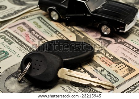 Car key, keychain,  car with an open door on  dollars