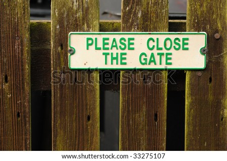 Sign on wooden gate reads please close the gate
