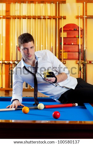 Billiard handsome player man drinking some alcohol in club
