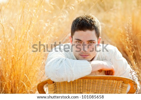 Autumn winter man portrait  in golden grass field with turtleneck sweater