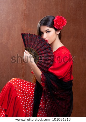 Flamenco dancer Spain woman gypsy with red rose and spanish hand fan