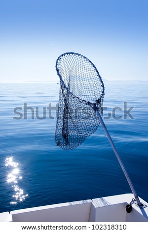 fishing landing net in blue sea at Mediterranean