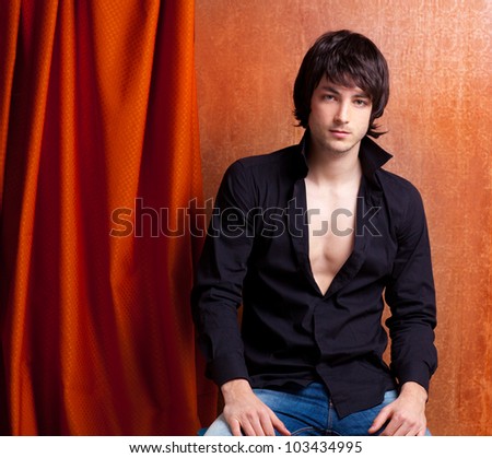 british indie pop rock look young man on orange brown retro background