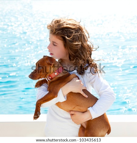 brunette kid girl with dog on the sea view from a boat