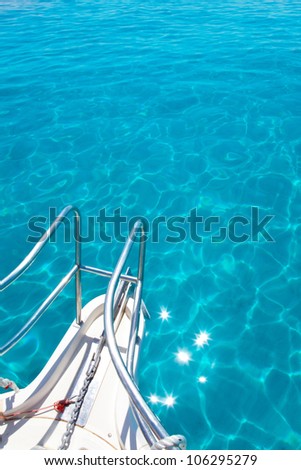 Balearic blue clean turquoise water from boat bow high angle view