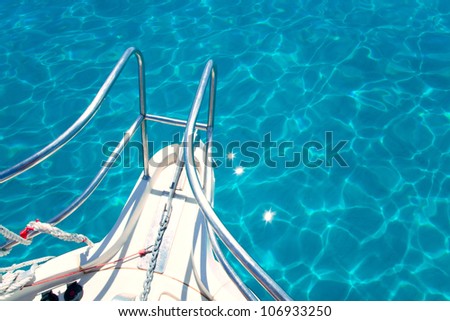 Balearic blue clean turquoise water from boat bow high angle view