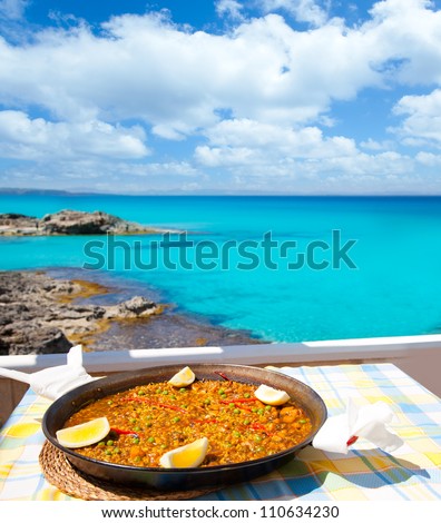 Paella mediterranean rice food by the Balearic Formentera island beach [photo-illustration]