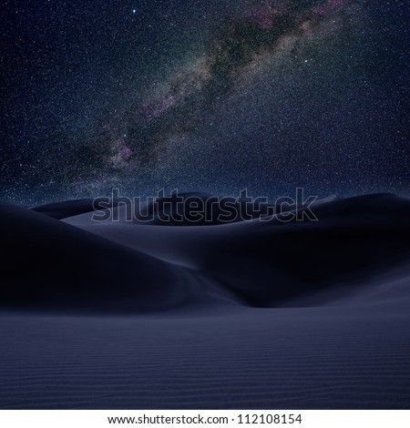 Desert dunes sand in milky way stars night sky  [photo illustration]