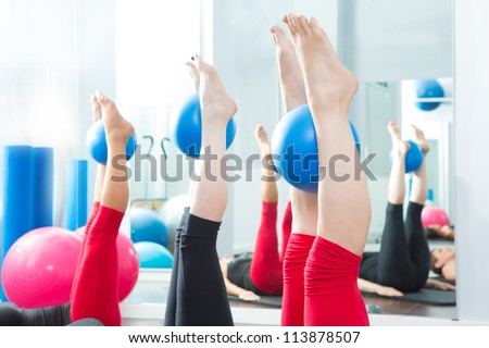 Aerobics pilates women feet  with yoga balls in a row on fitness class