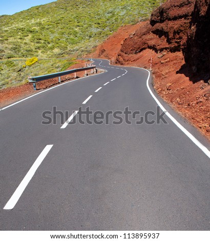 Canary Islands winding road curves in red mountain