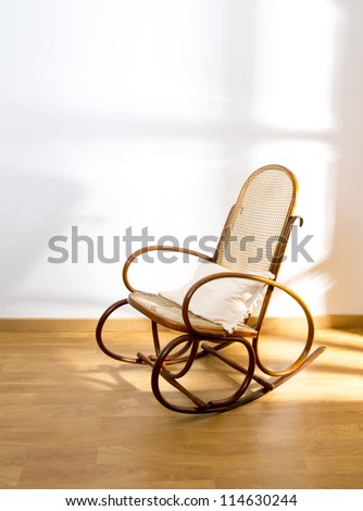 Golden retro rocker wooden swing chair on wood floor as a vintage memories