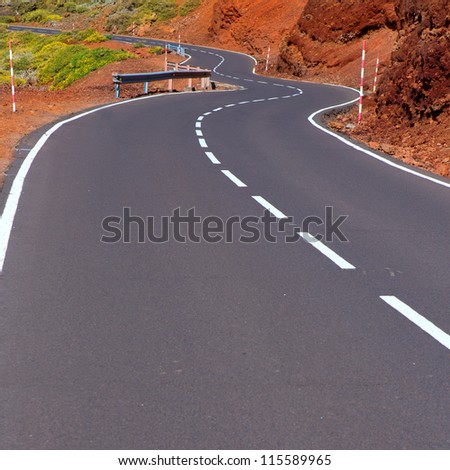Canary Islands winding road curves in red mountain