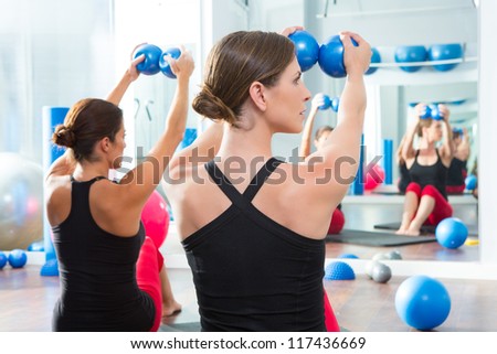Pilates toning ball in women fitness class rear mirror view