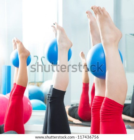 Aerobics pilates women feet  with yoga balls in a row on fitness class