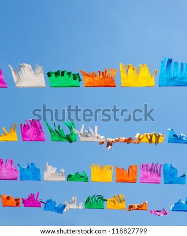 colorful tissue Paper fringe garland under blue sky in Spain fest