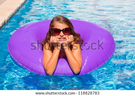 bikini kid girl with fashion sunglasses with purple inflatable pool ring
