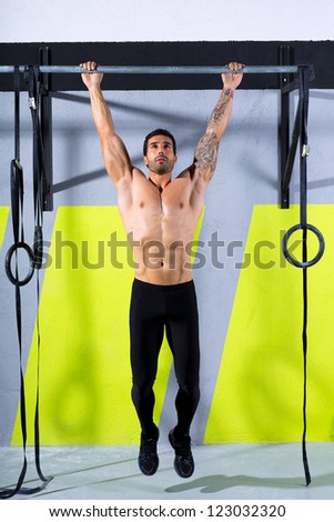 Fitness toes to bar man pull-ups 2 bars workout exercise at gym