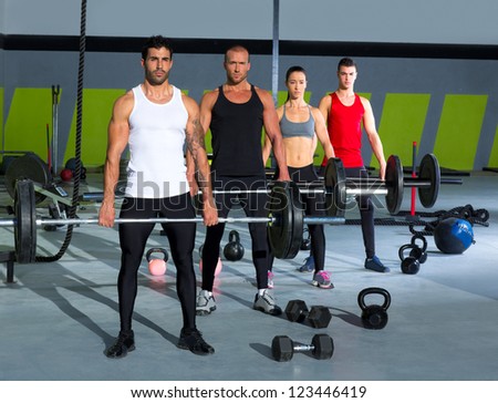 gym group with weight lifting bar workout in fitness exercise