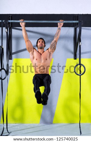 Fitness toes to bar man pull-ups 2 bars workout exercise at gym