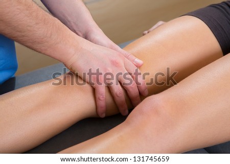 lymphatic drainage massage therapist hands on woman leg knee