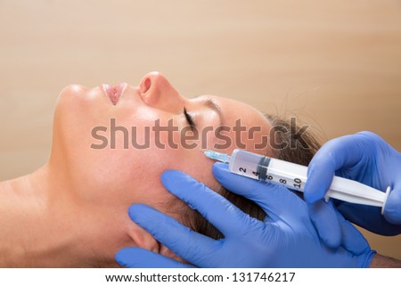 Anti aging facial mesotherapy with syringe closeup  on woman face