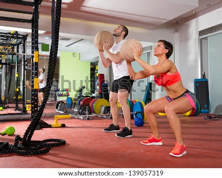 Crossfit ball fitness workout group woman and man at gym