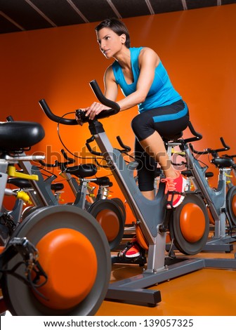 Aerobics spinning woman exercise workout at orange bikes gym