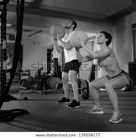 Crossfit ball fitness workout group woman and man at gym