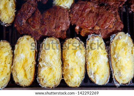 Barbecue grilled beef meat and foil potatoes prepared with cream and cheese