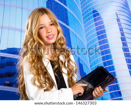 Children business student girl with tablet pc on urban blue buildings background