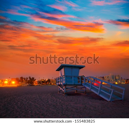 Santa Monica California sunset lifeguard tower and glowing city in USA