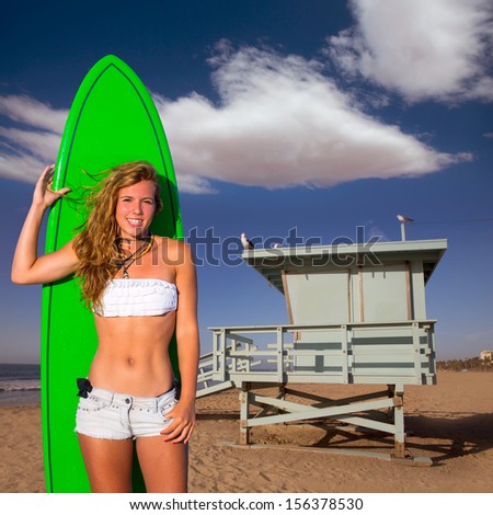 Blond surfer teen girl holding surfboard in Santa Monica Lifeguard house California photo mount