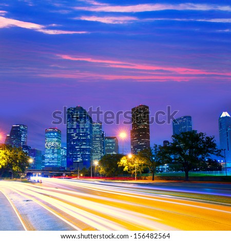Houston Texas modern skyline at sunset twilight with traffic headlights lights trace