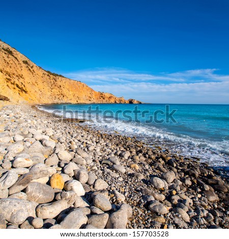 Ibiza Cala Jondal Beach with rolling stones in san Jose at Balearic Islands