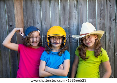Sister and friends sport kid girls portrait smiling happy on gray fence wood backyard