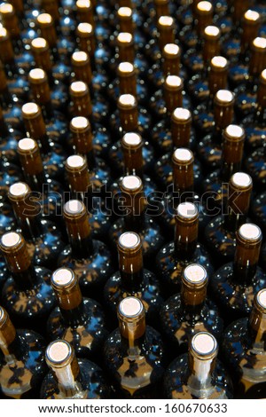 Wine bottles in a row as a pattern with cork  in Mediterranean winery