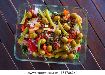 Mediterranean salad with tomato olives cucumber lettuce and nuts