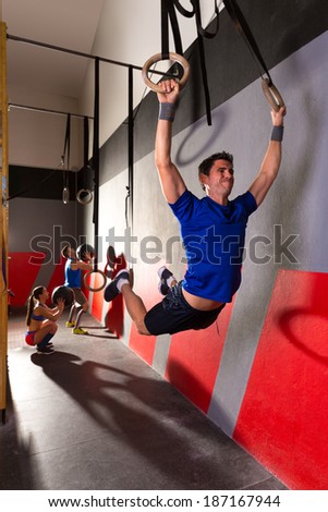 Muscle ups rings man swinging workout exercise at gym