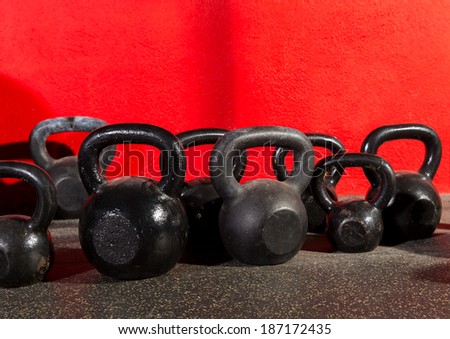 Kettlebells weights in a workout gym in red background
