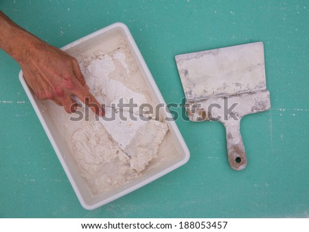 Platering tools for plaster like plaste trowel spatula on green drywall plasterboard