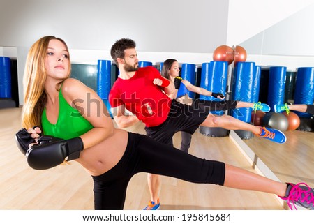 Boxing aerobox group low kick training at fitness gym mirror