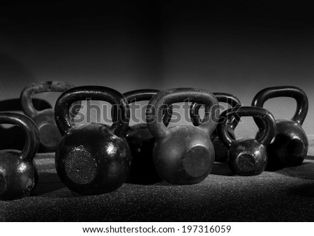 Kettlebells weights in a workout gym in black and white